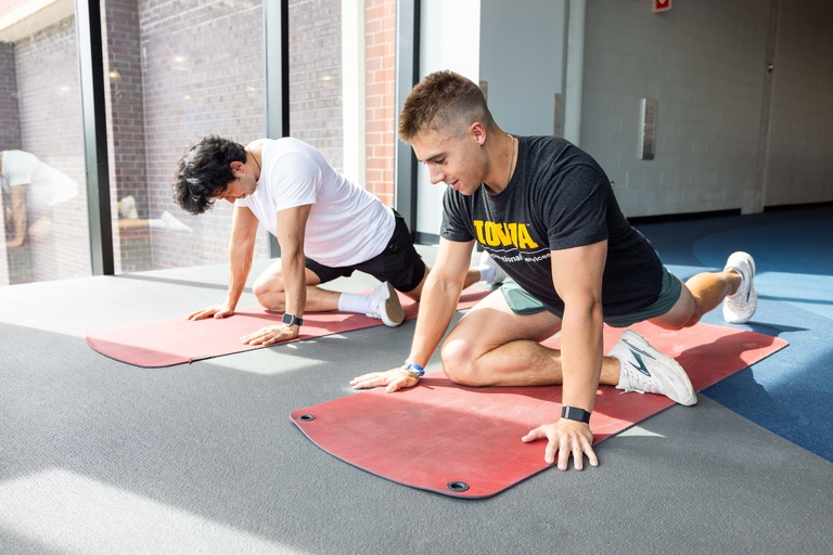 Personal Trainers working with a client.